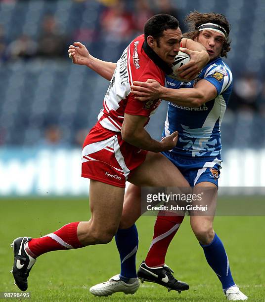George Carmont of Wigan Warriors struggles to get away during the Engage Super League game between Wigan Warriors and Huddersfield Giants at...