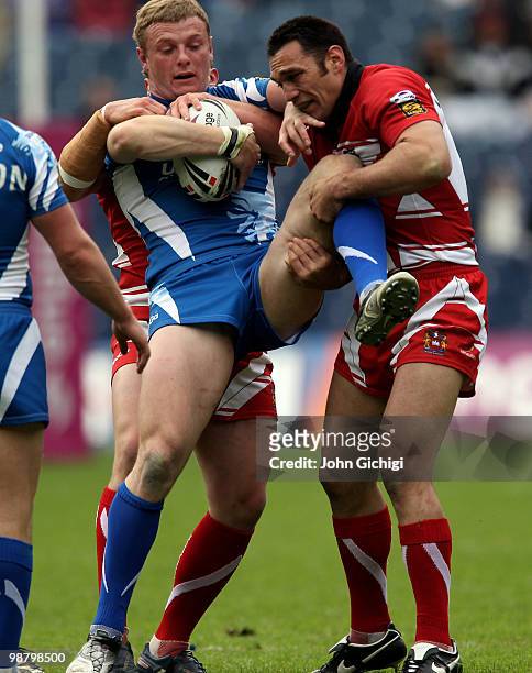 Graeme Horne of Huddersfield Giants is tackled during the Engage Super League game between Wigan Warriors and Huddersfield Giants at Murrayfield on...