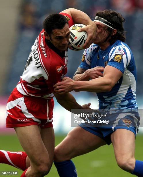 George Carmont of Wigan Warriors struggles to get away during the Engage Super League game between Wigan Warriors and Huddersfield Giants at...