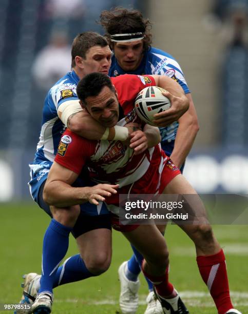 George Carmont of Wigan Warriors struggles to get away during the Engage Super League game between Wigan Warriors and Huddersfield Giants at...