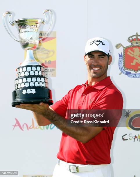 Alvaro Quiros of Spain with the winners trophy after the final round of the Open de Espana at the Real Club de Golf de Seville on May 2, 2010 in...