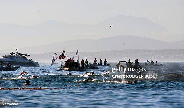 Swimmers swim in amongst the flotilla of support boats, in Table Bay, during the Freedom Swim from Robben Island, where Nelson Mandela was...