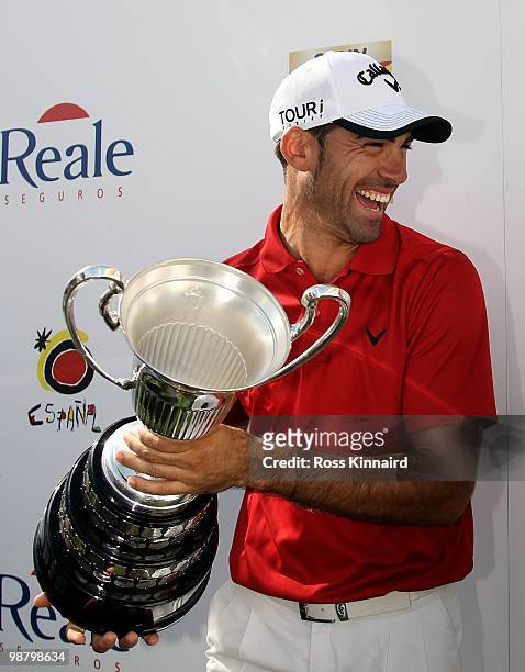 Alvaro Quiros of Spain with the winners trophy after the final round of the Open de Espana at the Real Club de Golf de Seville on May 2, 2010 in...