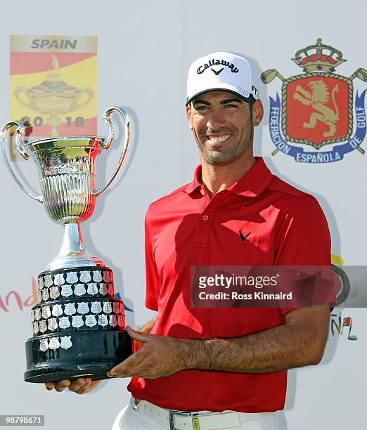 Alvaro Quiros of Spain with the winners trophy after the final round of the Open de Espana at the Real Club de Golf de Seville on May 2, 2010 in...
