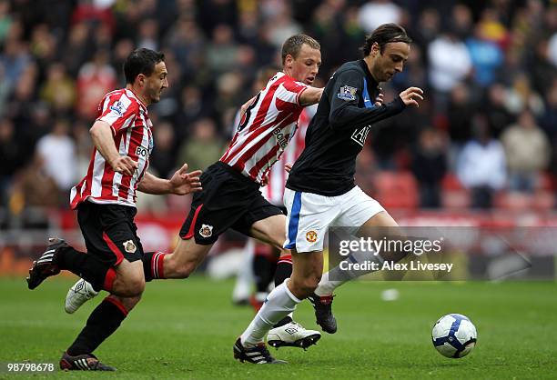 Dimitar Berbatov of Manchester United beats Steed Malbranque and David Meyler of Sunderland during the Barclays Premier League match between...