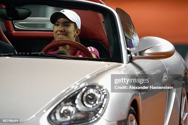 Justine Henin of Belgium drives with her winners present, a Porsche Boxter Spyder after winning her final match against Samantha Stosur of Australia...