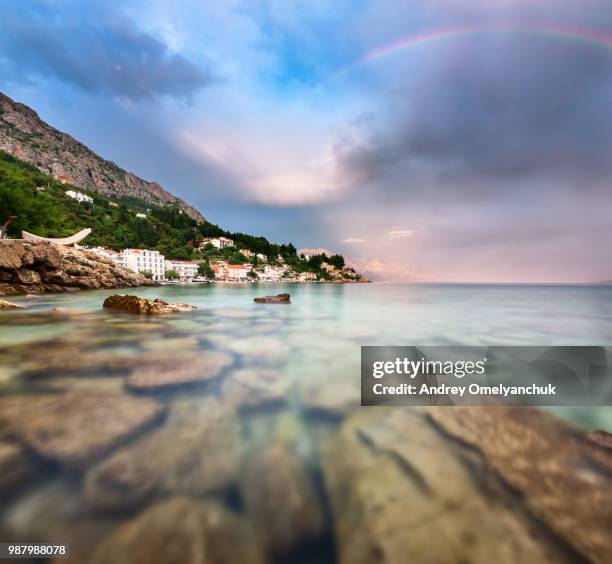 rainbow over rocky beach in croatia - rainbow beach stockfoto's en -beelden