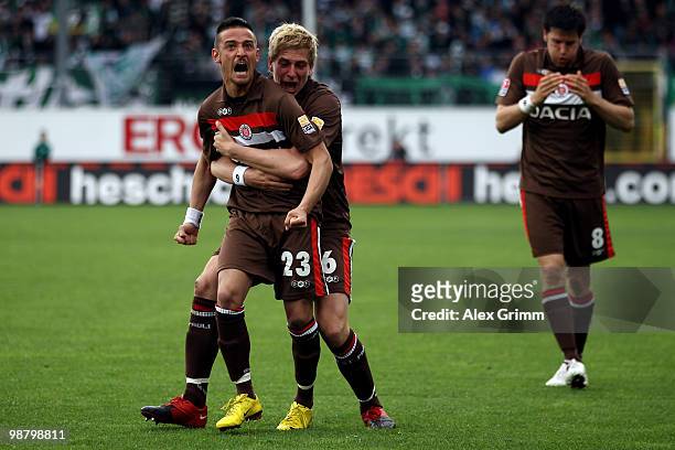 Deniz Naki of St. Pauli celebrates his team's first goal with team mates Bastian Oczipka and Florian Bruns of St. Pauli during the Second Bundesliga...