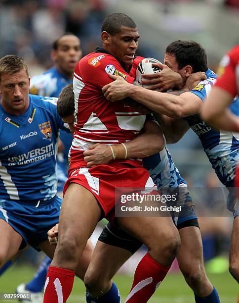 Karl Pryce of Wigan Warriors struggles to get away during the Engage Super League game between Wigan Warriors and Huddersfield Giants at Murrayfield...