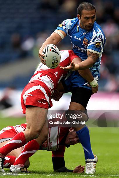 Paul Whatuira of Huddersfield Giants is tackled into touch during the Engage Super League game between Wigan Warriors and Huddersfield Giants at...