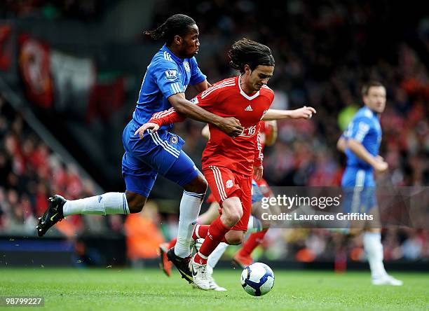 Alberto Aquilani of Liverpool holds off the challenge from Didier Drogba of Chelsea during the Barclays Premier League match between Liverpool and...