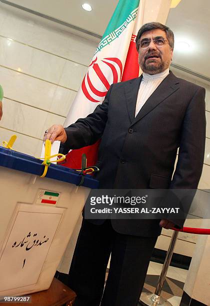 Iranian ambassador in Kuwait Ali Jannati casts his vote at the Iranian embassy in Kuwait City on June 12, 2009. Iranians queued up to vote on Friday...