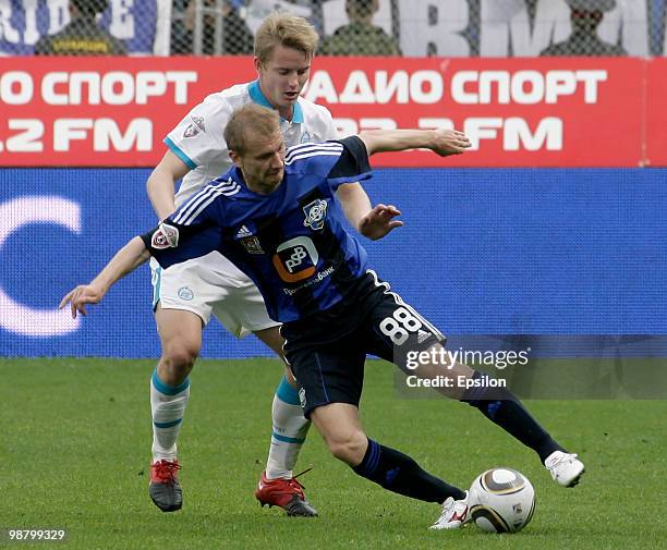 Aleksei Ivanov of FC Saturn Moscow Oblast battles for the ball with Tomas Hubocan of FC Zenit St. Petersburg during the Russian Football League...