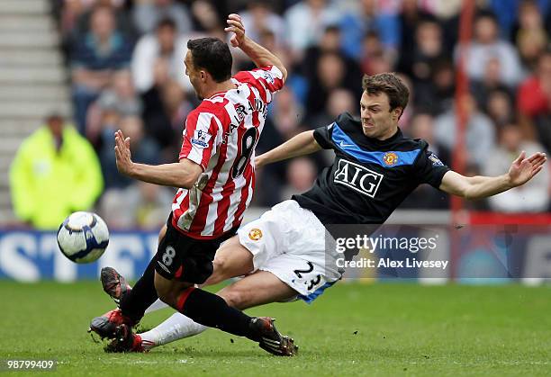 Steed Malbranque of Sunderland fouls Johnny Evans of Manchester United during the Barclays Premier League match between Sunderland and Manchester...