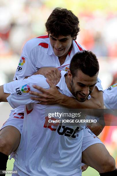 Sevilla's midfielder Alvaro Negredo celebrates with Argentinian midfielder Diego Perotti after scoring against Atletico Madrid during a Spanish...