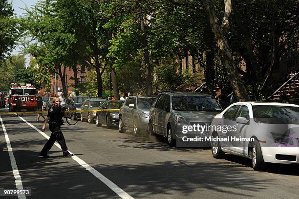 Police officer walks past a smoking minivan on May 2, 2010 in the Carroll Gardens neighborhood of the Brooklyn borough of New York City. A series of...