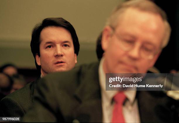 Brett Kavanaugh, associate counsel in the Office of Independent Counsel Kenneth Starr, sits behind Starr during his testimony before the House...