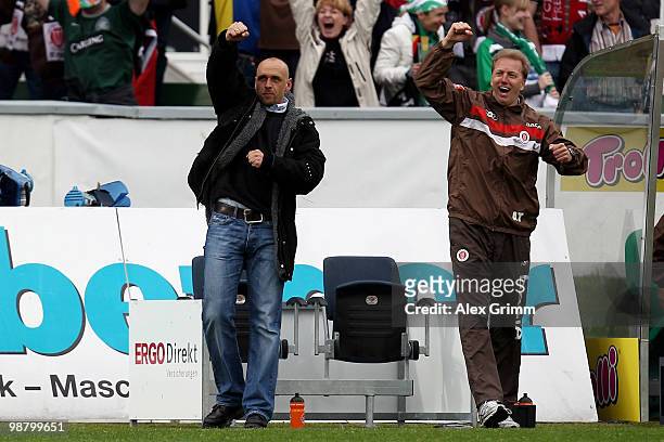 Head coach Holger Stanislawski of St. Pauli and assistant coach Andre Trulsen celebrate after the Second Bundesliga match between SpVgg Greuther...