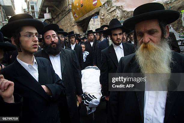 Ultra-Orthodox Jews of the anti-Zionist group Neturei Karta carry the body of Rabbi Moshe Hirsch during his funeral in the Mea Shearim neighbourhood...