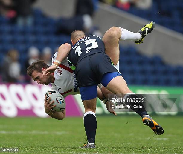 Paul Clough of St Helens gets up lifted by Michael Ratu of Hull Kingston Rovers during the Engage Rugby Super League Magic Weekend match between St...
