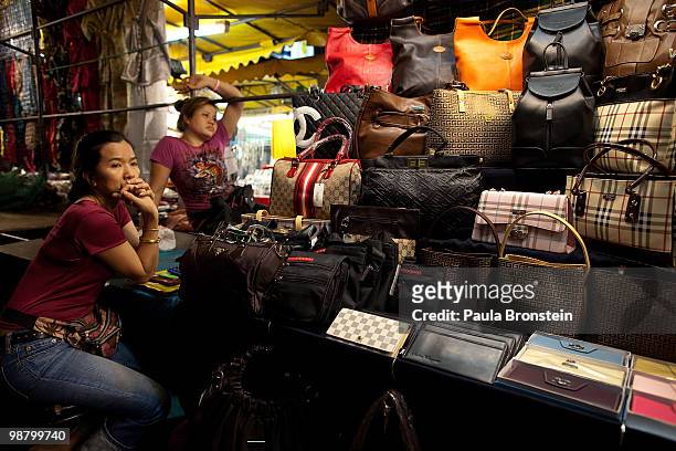 Thai women wait for business at a stall inside the night market at Patpong that is usually packed with tourists May 2, 2010 in Bangkok, Thailand....