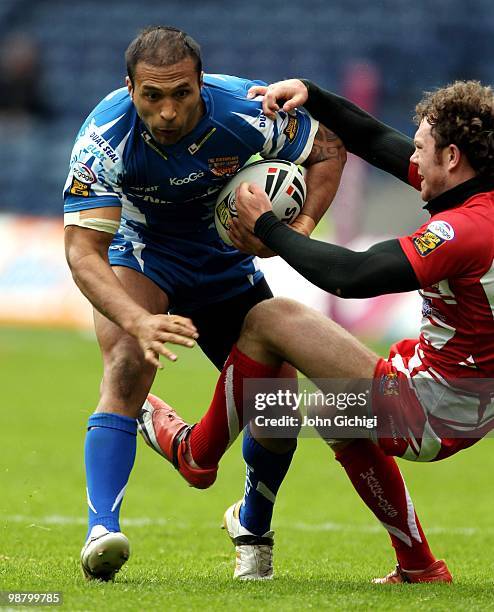 Paul Whatuira of Huddersfield Giants is tackled during the Engage Super League game between Wigan Warriors and Huddersfield Giants at Murrayfield on...