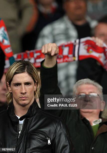 Spectator points to Liverpool's Spanish forward Fernando Torres as he takes his seat before their Premiership football match against Chelsea at...
