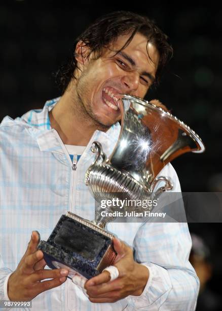 Rafael Nadal of Spain bites the trophy after defeating David Ferrer of Spain in the final during day eight of the ATP Masters Series - Rome at the...