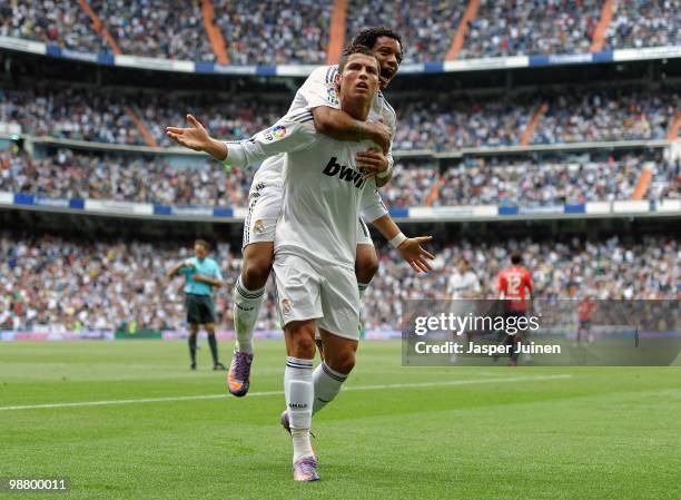 Cristiano Ronaldo of Real Madrid celebrates scoring his sides equalizing goal with his teammate Marcelo Vieira during the La Liga match between Real...