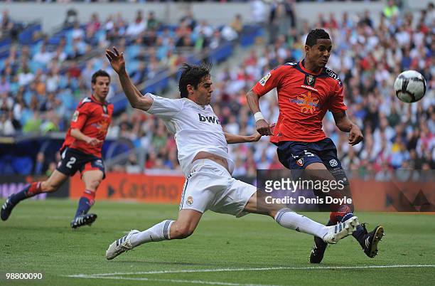 Kaka of Real Madrid shoots past Roversio Rodrigues de Barros of Osasuna during the La Liga match between Real Madrid and CA Osasuna at Estadio...