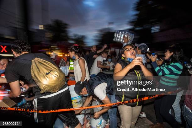 Rescuers, volunteers and firefighters work after the magnitude 7.1 earthquake that jolted central Mexico damaging buildings, knocking out power and...