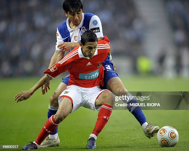 Benfica's Argentinian forward Angel Di Maria vies with FC Porto´s defender Jorge Fucile of Uruguay during their Portuguese first league football...