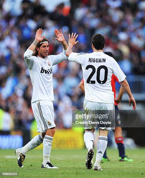 Sergio Ramos and Gonzalo Higuain of Real Madrid celebrate after Real scored their 3rd goal during the La Liga match between Real Madrid and CA...