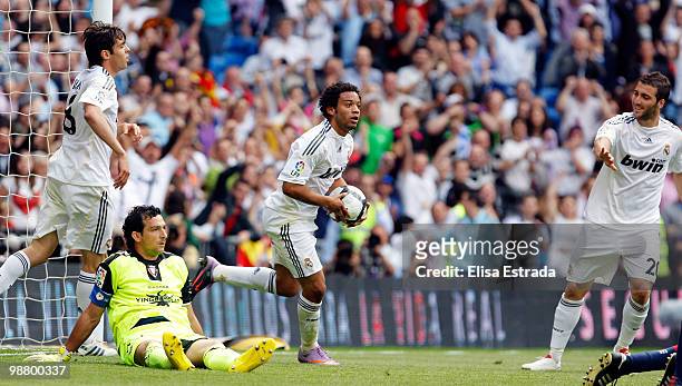 Marcelo of Real Madrid celebrates with Kaka and Gonzalo Higuain during the La Liga match between Real Madrid and CA Osasuna at Estadio Santiago...