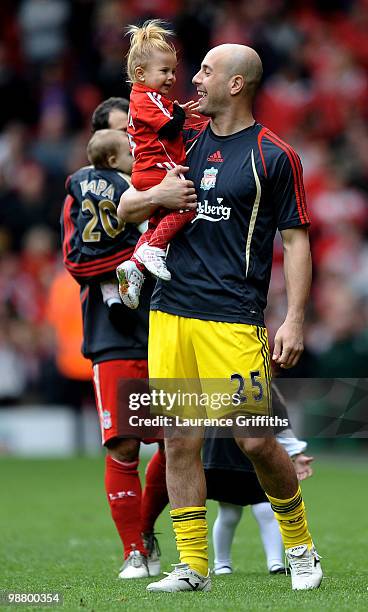 Pepe Reina walk on the pitch with one of his children following the final home game of the year during the Barclays Premier League match between...