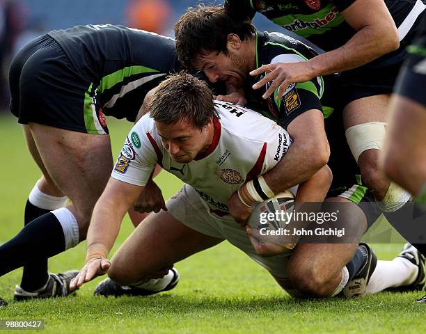 Andrew Dixon of St Helens is tackled during the Engage Rugby Super League Magic Weekend match between St Helens and Hull Kingston Rovers at...