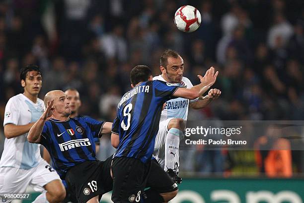 Thiago Motta and Esteban Cambiasso of FC Internazionale Milano with Cristian Brocchi of SS Lazio compete for the ball during the Serie A match...