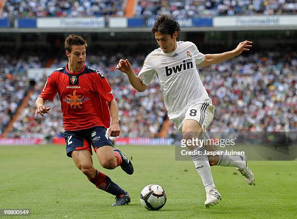Kaka of Real Madrid duels for the ball with Cesar Tanco of Osasuna during the La Liga match between Real Madrid and Osasuna at the Estadio Santiago...