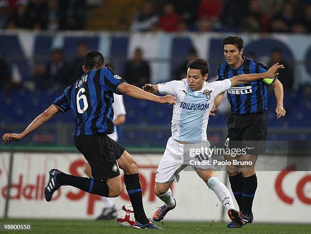 Lucio and Cristian Zanetti of FC Internazionale Milano with Mauro Matias Zarate of SS Lazio compete for the ball during the Serie A match between SS...