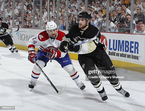 Alex Goligoski of the Pittsburgh Penguins skates in front of the defense of Tomas Plekanec of the Montreal Canadiens in Game Two of the Eastern...