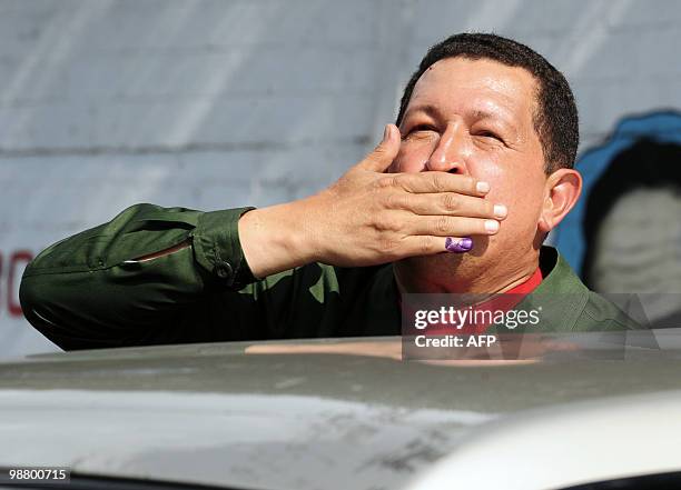 Venezuelan President Hugo Chavez throws a goodbye kiss to the crowd after casting his vote in the primary elections of the PSUV ruling party for...