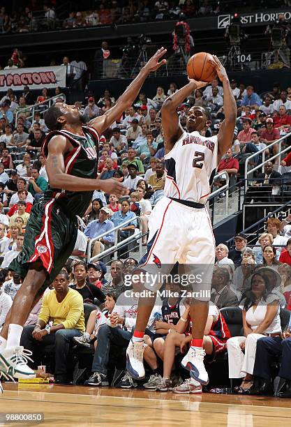 Guard Joe Johnson of the Atlanta Hawks shoots over guard John Salmons of the Milwaukee Bucks during Game Seven of the Eastern Conference...