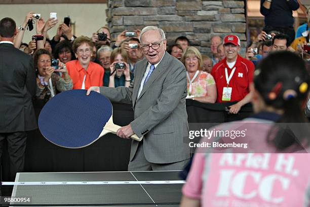 Warren Buffett, chief executive officer of Berkshire Hathaway, plays table tennis with Ariel Hsing, the number one U.S. Player under twenty, on the...