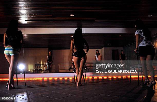 Group of young women perform during practice at a Pole Dance academy in Medellin, Antioquia department, Colombia on April 27, 2010. Pole Dance,...