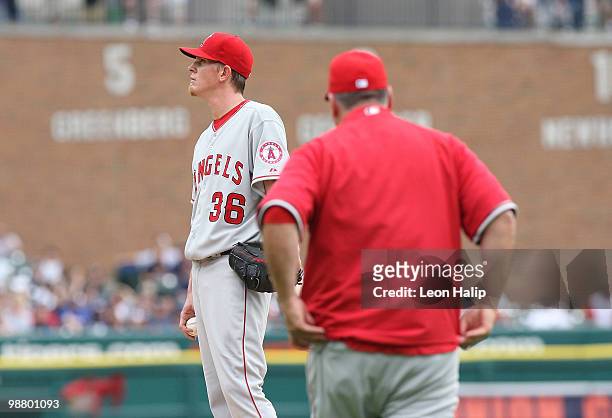 Jered Weaver of the Los Angeles Angels of Anaheim reacts as manager Mike Scioscia walks to the mound during the fifth inning of the game against the...