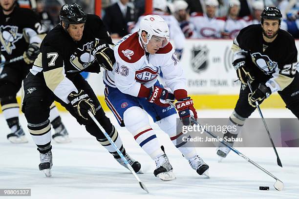 Mark Eaton of the Pittsburgh Penguins defends as Michael Cammalleri of the Montreal Canadiens controls the puck in Game Two of the Eastern Conference...