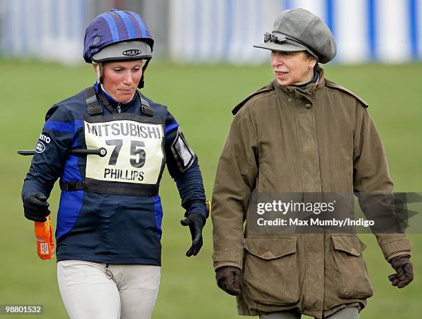 Zara Phillips pulls a face as she talks with her mother Princess Anne, Princess Royal after completing the cross country phase of the Badminton Horse...