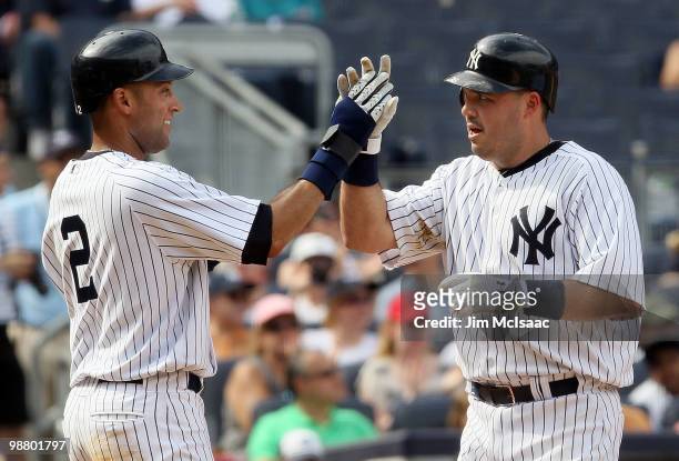 Derek Jeter and Nick Johnson of the New York Yankees celebrate after scoring in the seventh inning against the Chicago White Sox after a double from...