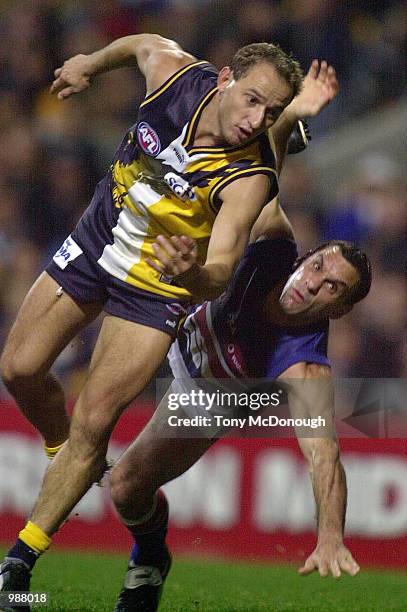 Tony Liberatore for Western Bulldogs tackles Phillip Matera for The West Coast Eagles, in the match between The West Coast Eagles and The Western...