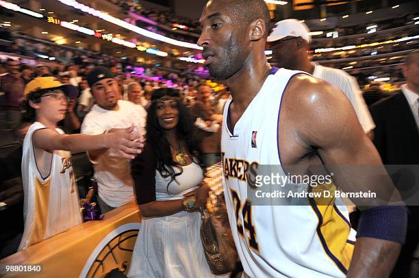 Kobe Bryant of the Los Angeles Lakers walks by his mother, Pam, following his team's victory over the Utah Jazz in Game One of the Western Conference...